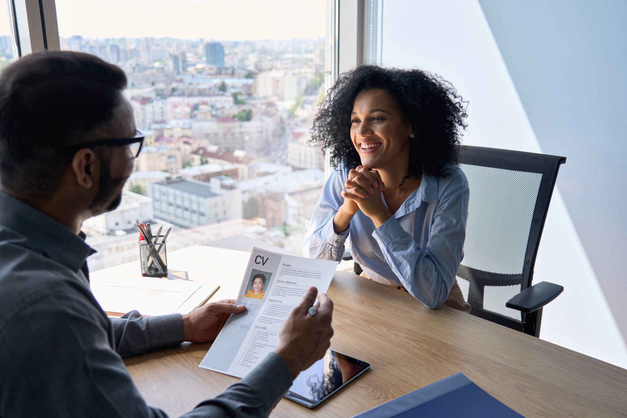 Friendly interview between indian hr manager and African American applicant.